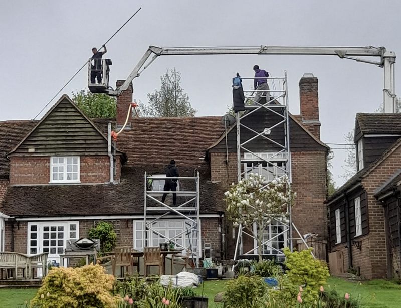 The Moss Cleaners using cherry picker and scaffolding to clean roof safely and professionally in Southam, Warwickshire